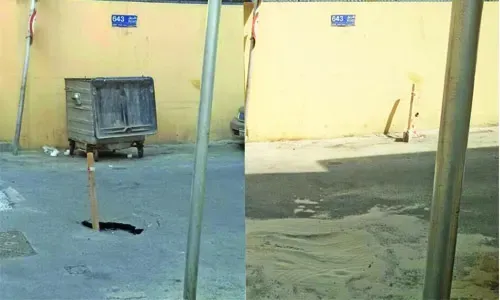 Hole in Manama road covered with loose sand!